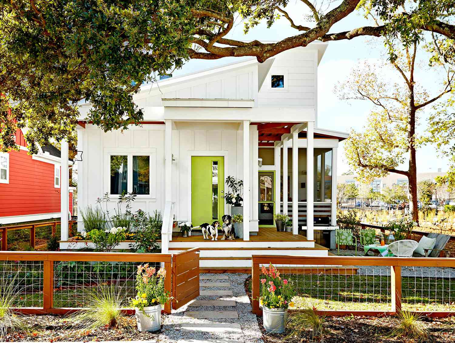 White house with green front door and dogs on porch