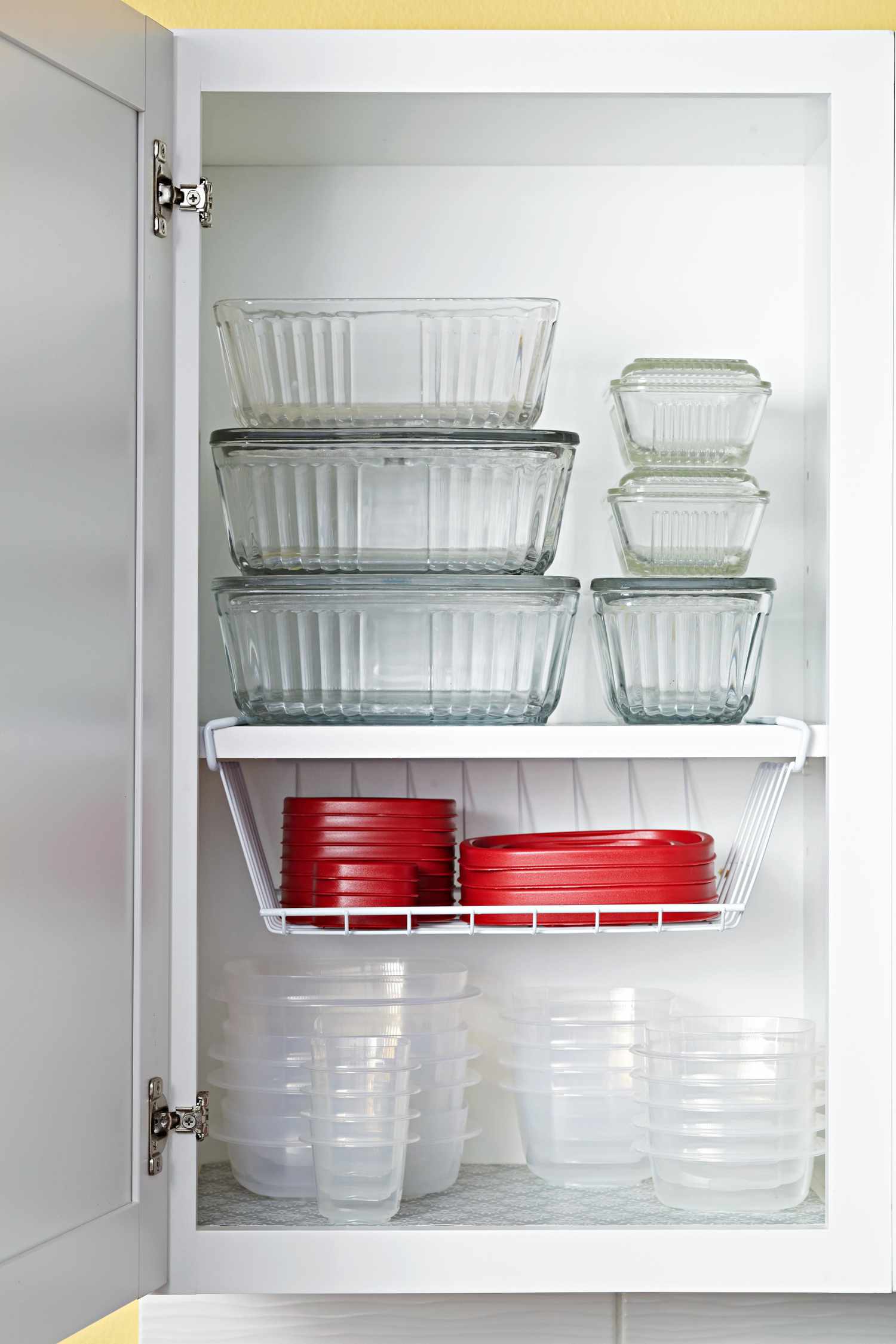 organized glass and plastic storage containers with red lids