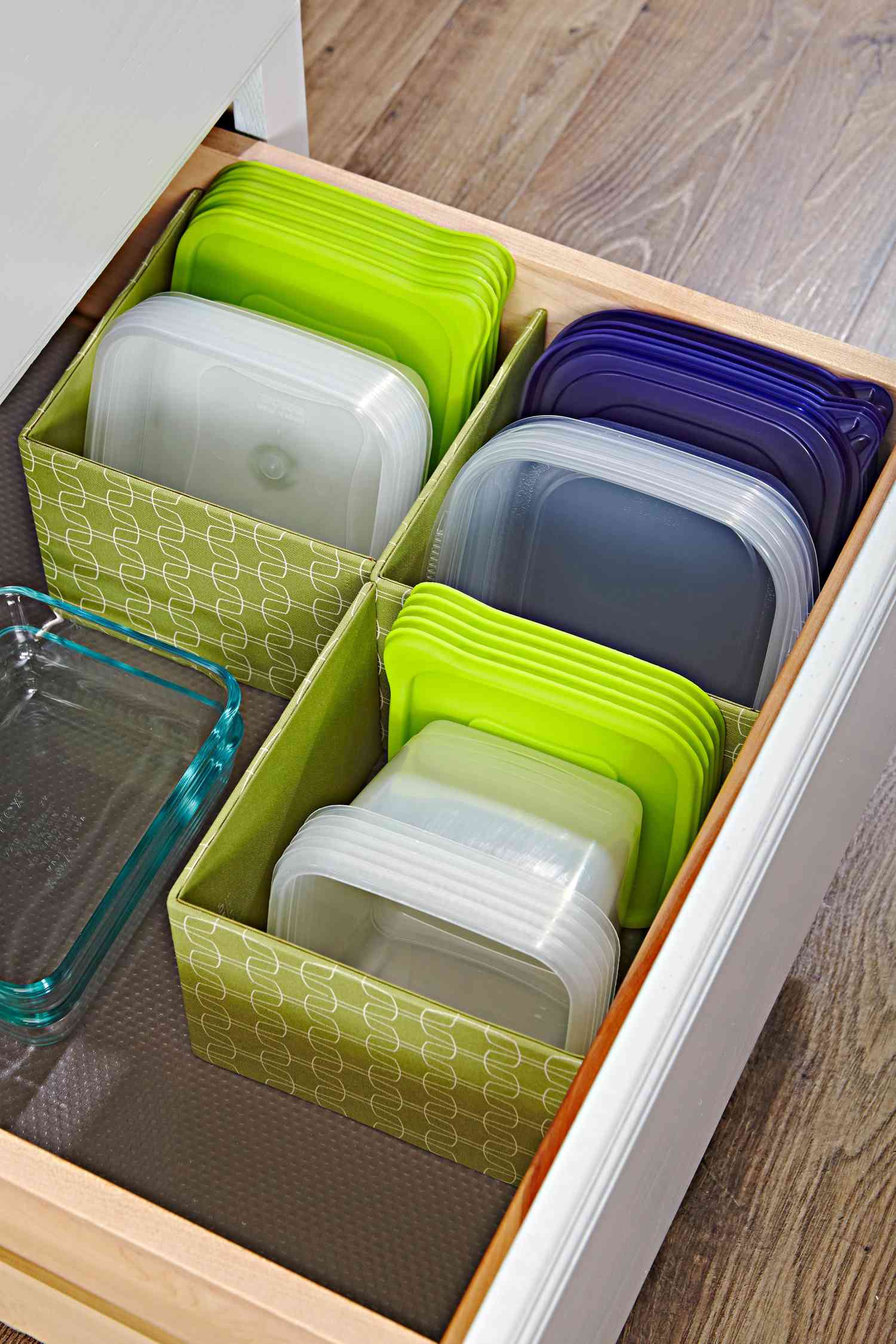 organized plastic food storage containers with green and blue lids