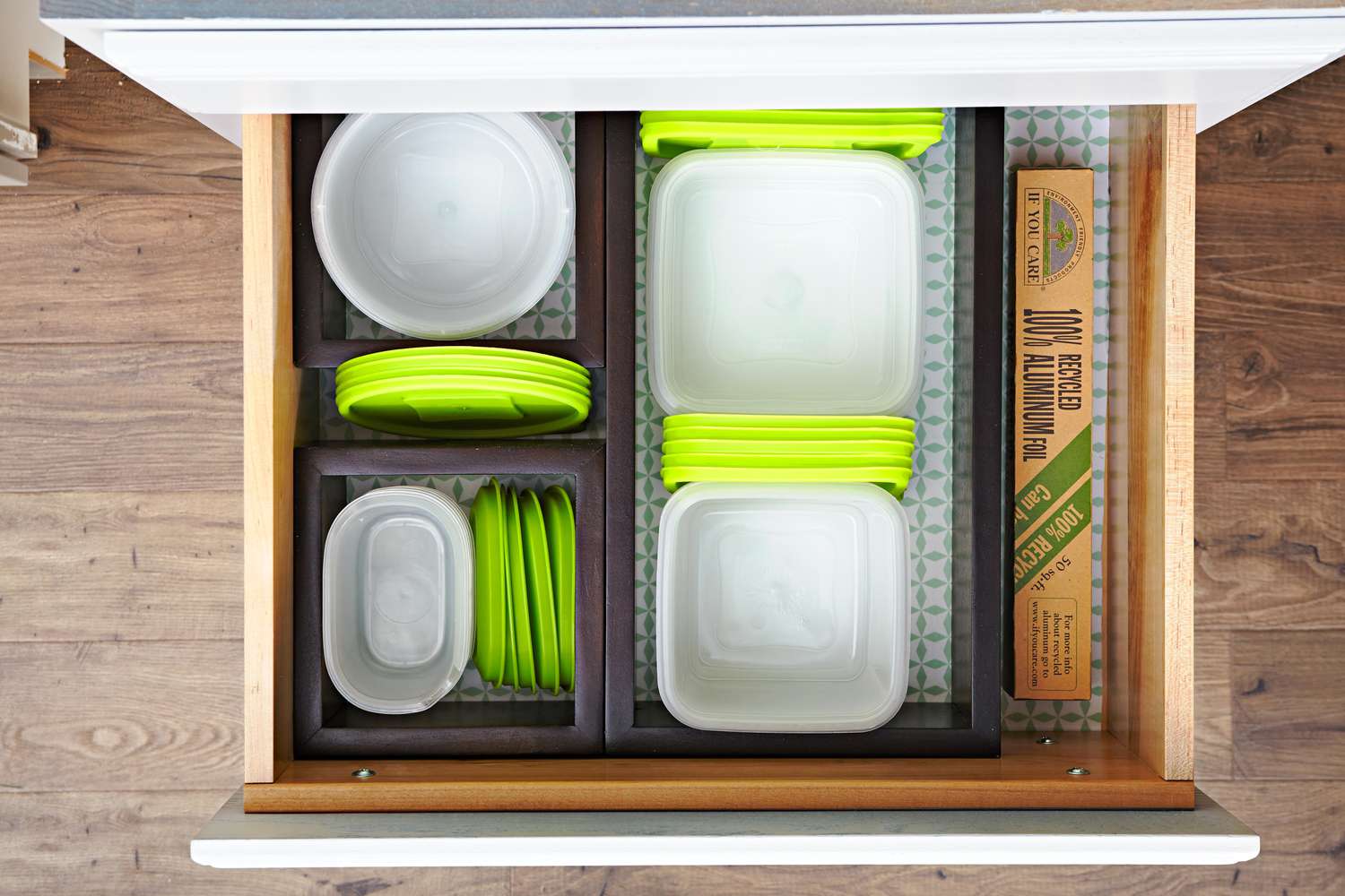 organized green lidded food storage containers in drawer