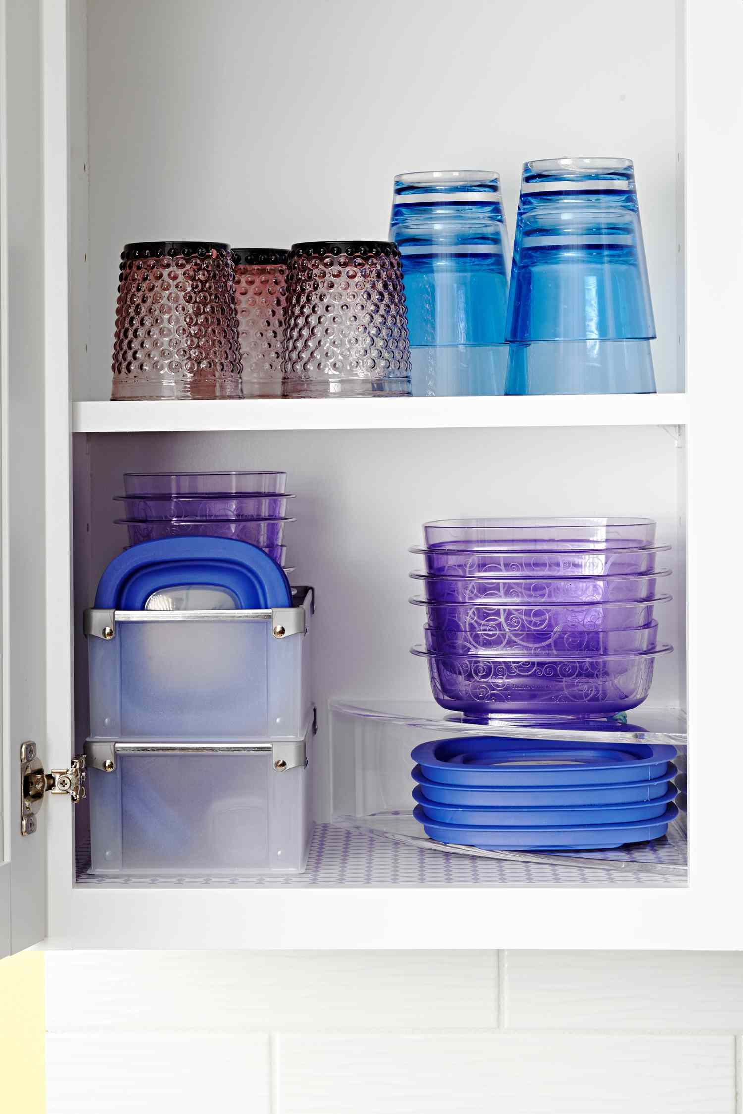 organized cupboard of blue and purple food storage containers
