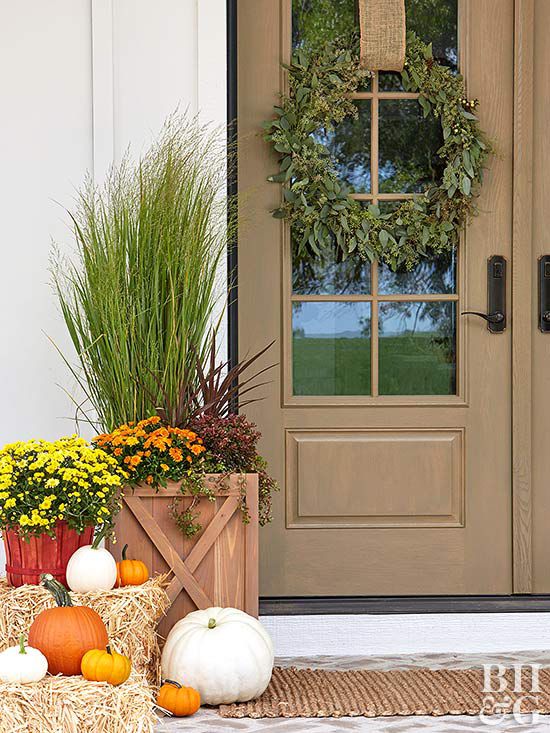 fall front door with wreaths, pumpkins, hay barrel