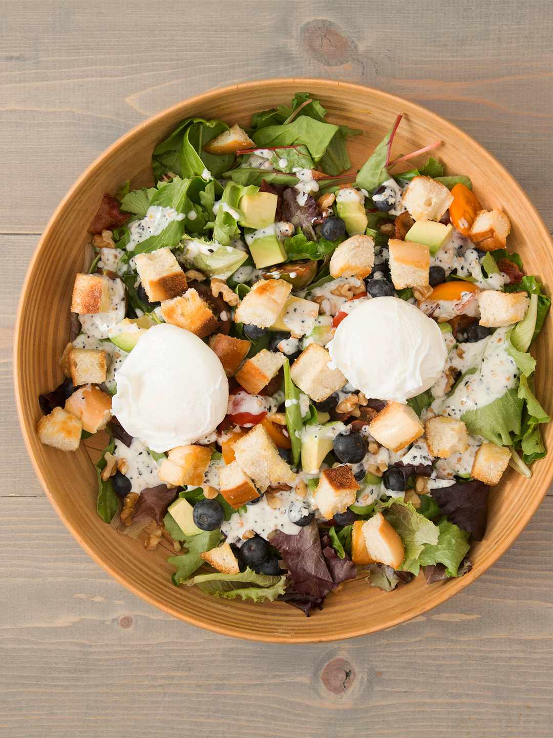 Breakfast Salad with mozzarella cheese balls croutons and berries