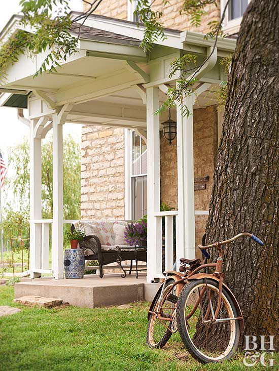 front of house with bike leaning against tree
