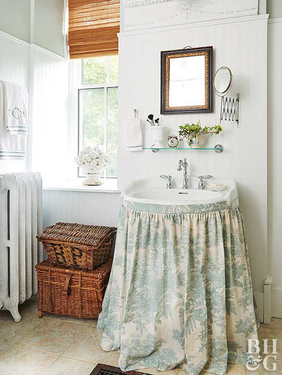 bathroom with light blue and white floral sink skirt