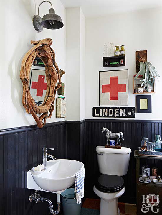 rustic designed powder room bathroom with vintage wall art above toilet