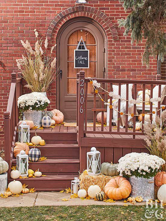 halloween front door with pumpkins and mums