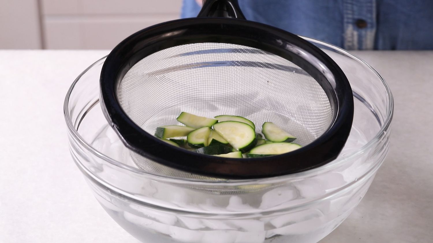 Dipping zucchini slices in ice water
