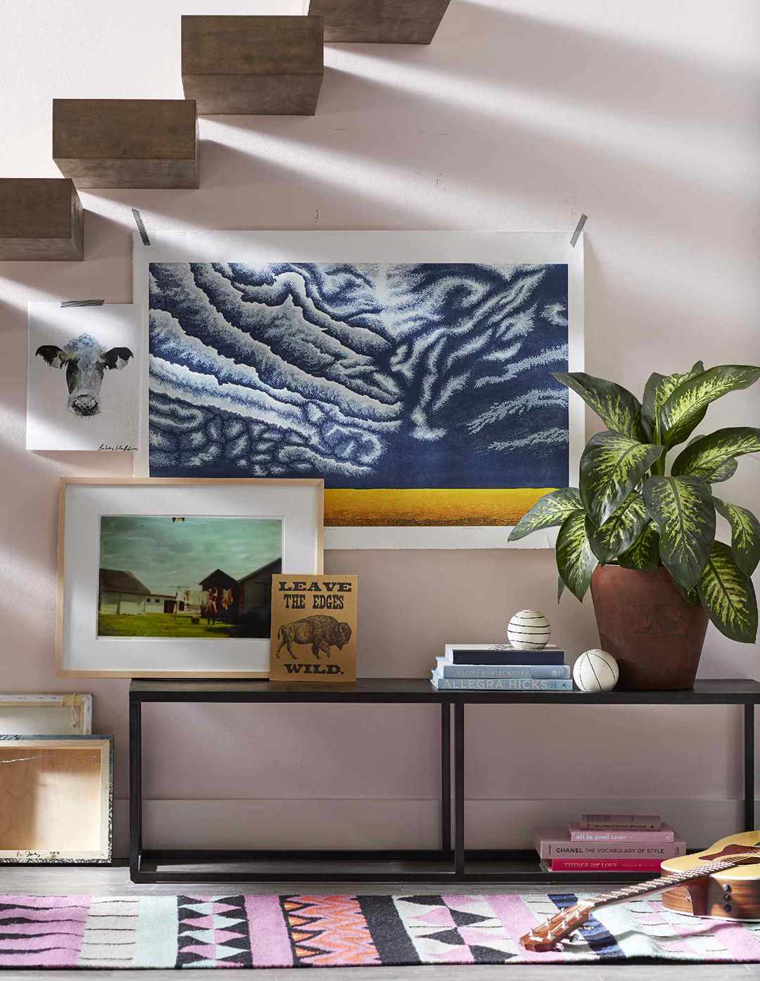 living room with floating staircase and artwork