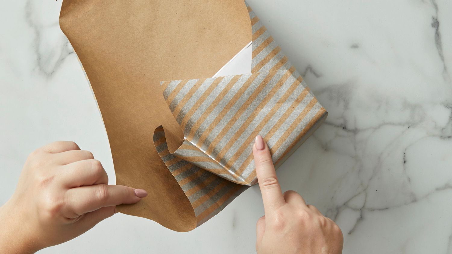 Wrapping brown kraft paper over a square package