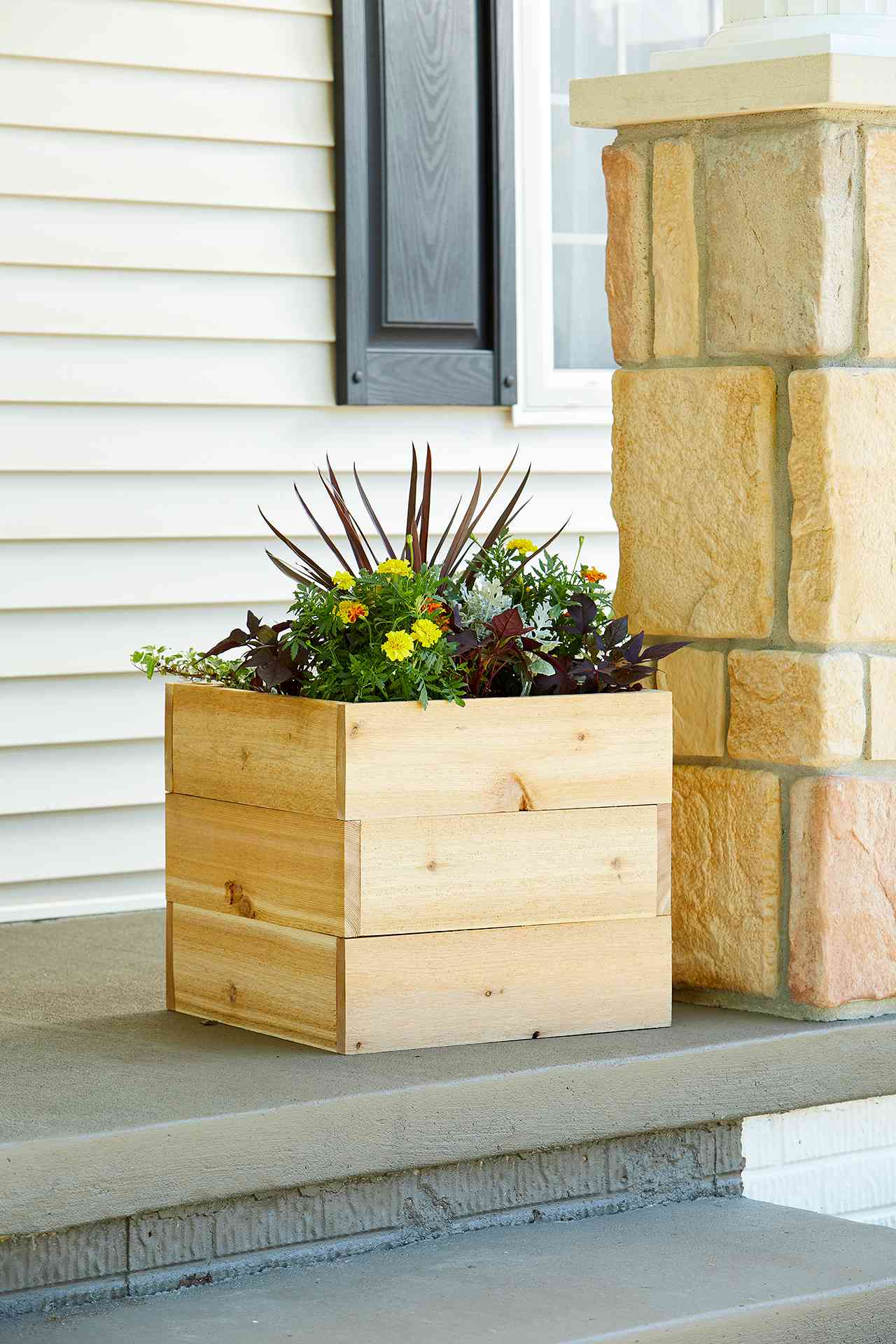 square unstained DIY wood planter on porch