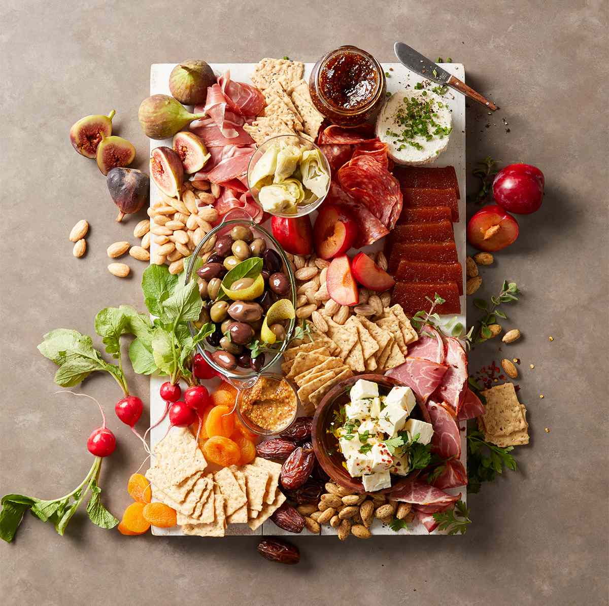 overflowing white charcuterie board
