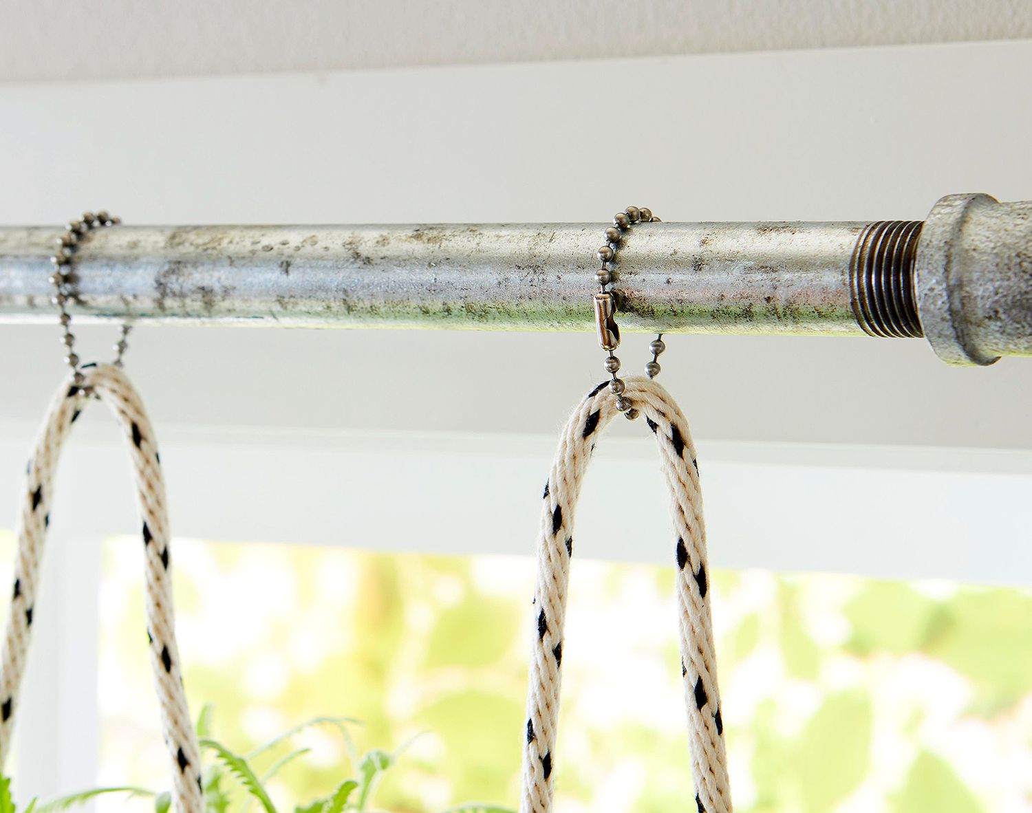 herb planters with rope hanging from pipe