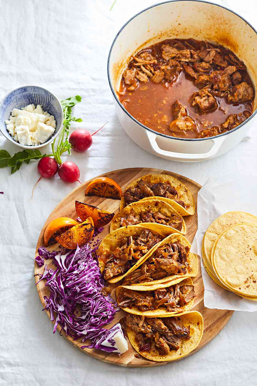 Chipotle Pork Tacos with sliced red cabbage and roasted lemons