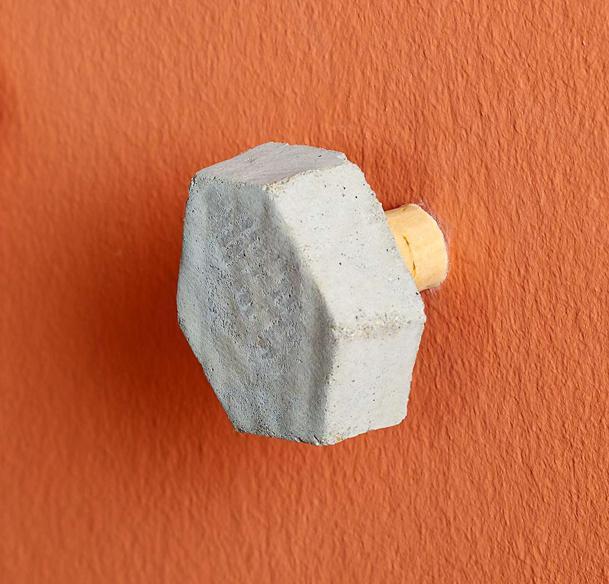 close up of wall hook with wine cork