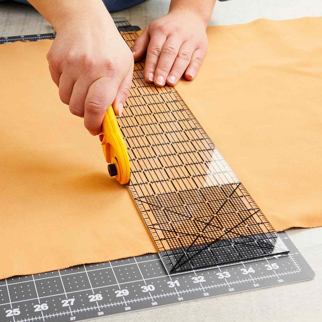 use rotary cutter to cut fabric