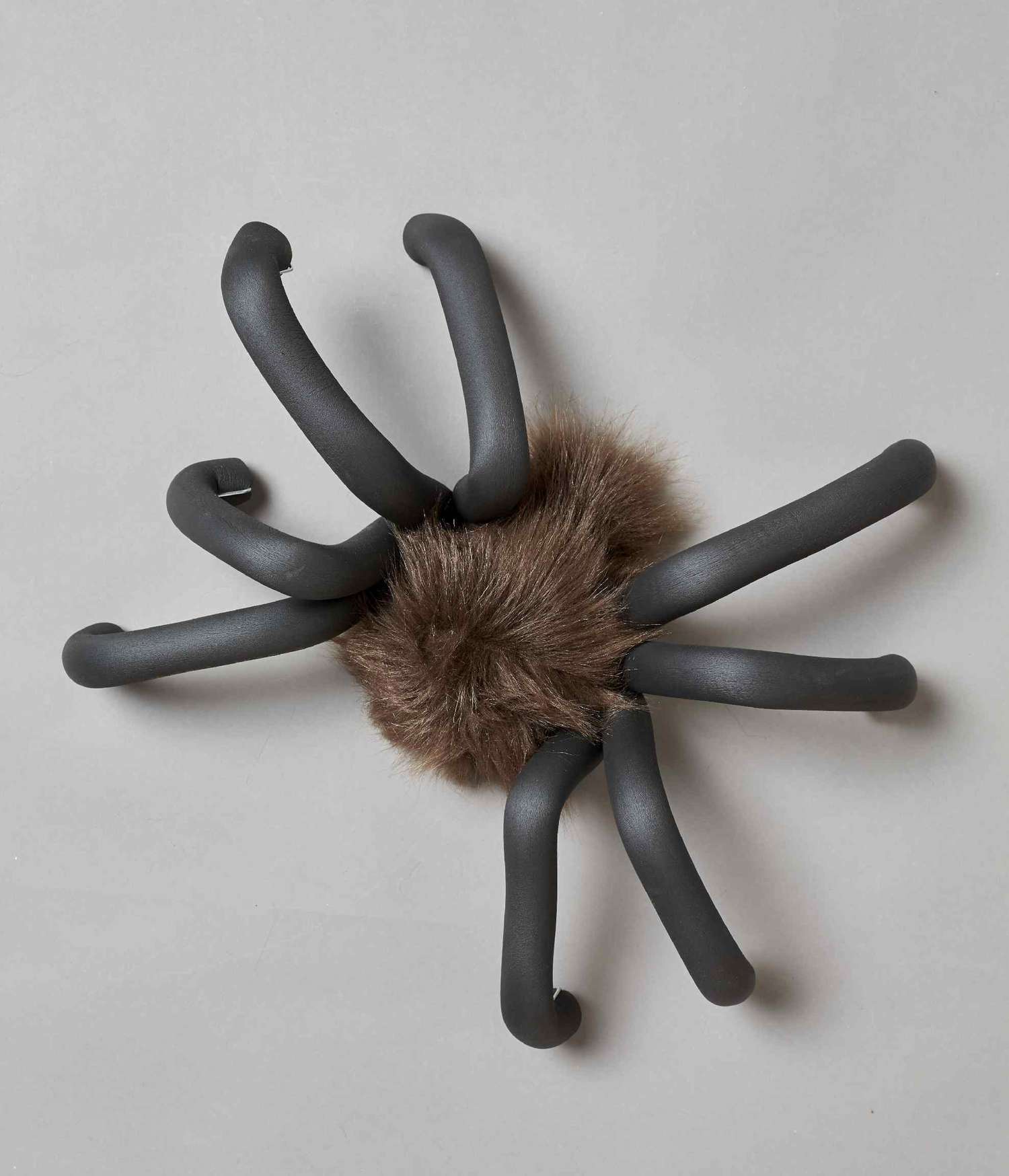 Furry brown spider with eight black foam legs