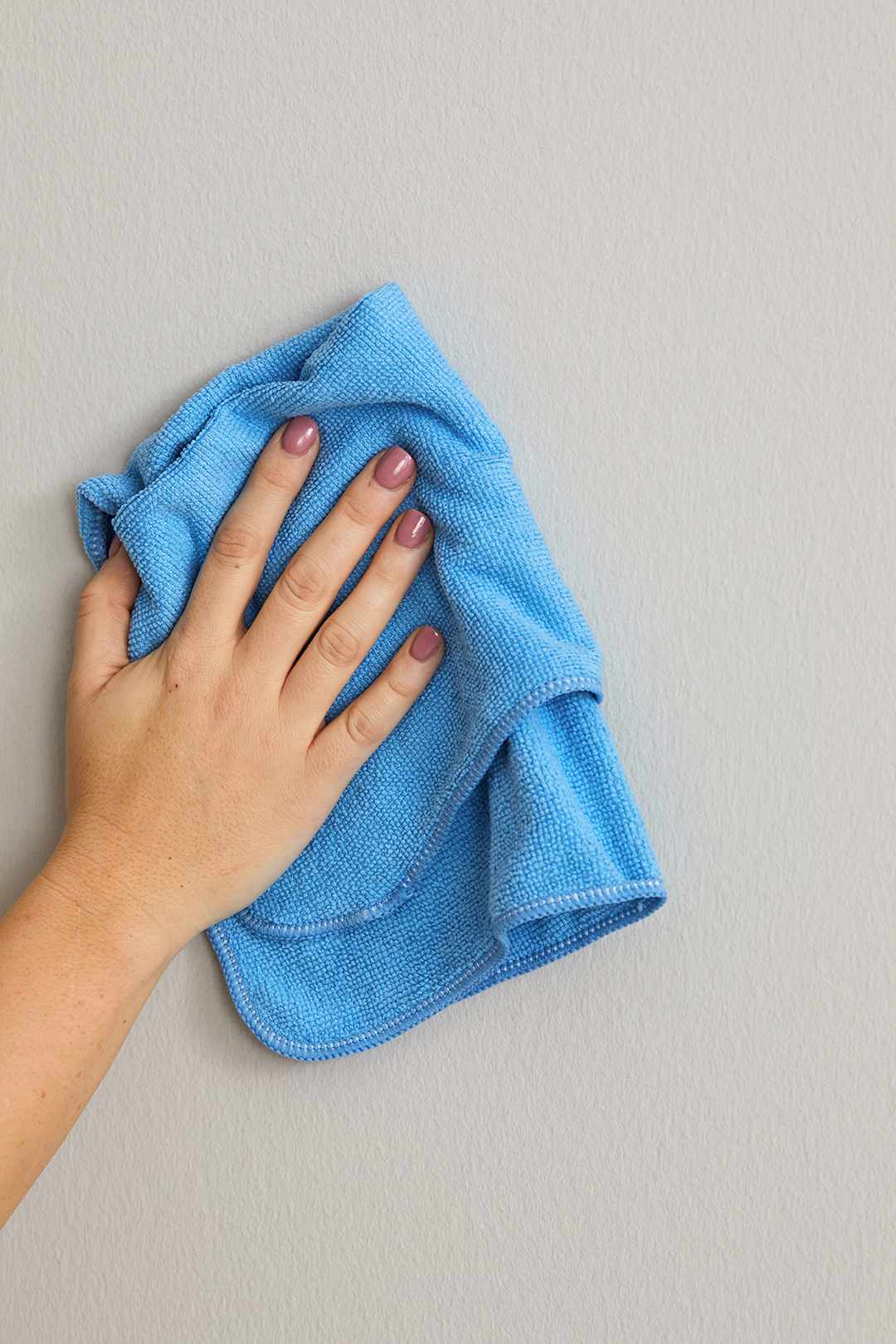 cleaning wall with blue cloth