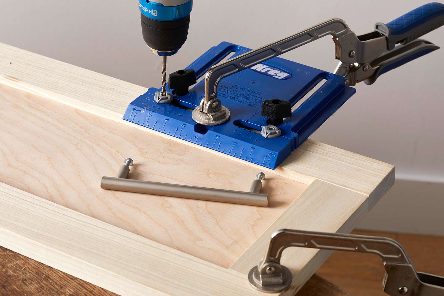 using tools to install handle for wood cabinets