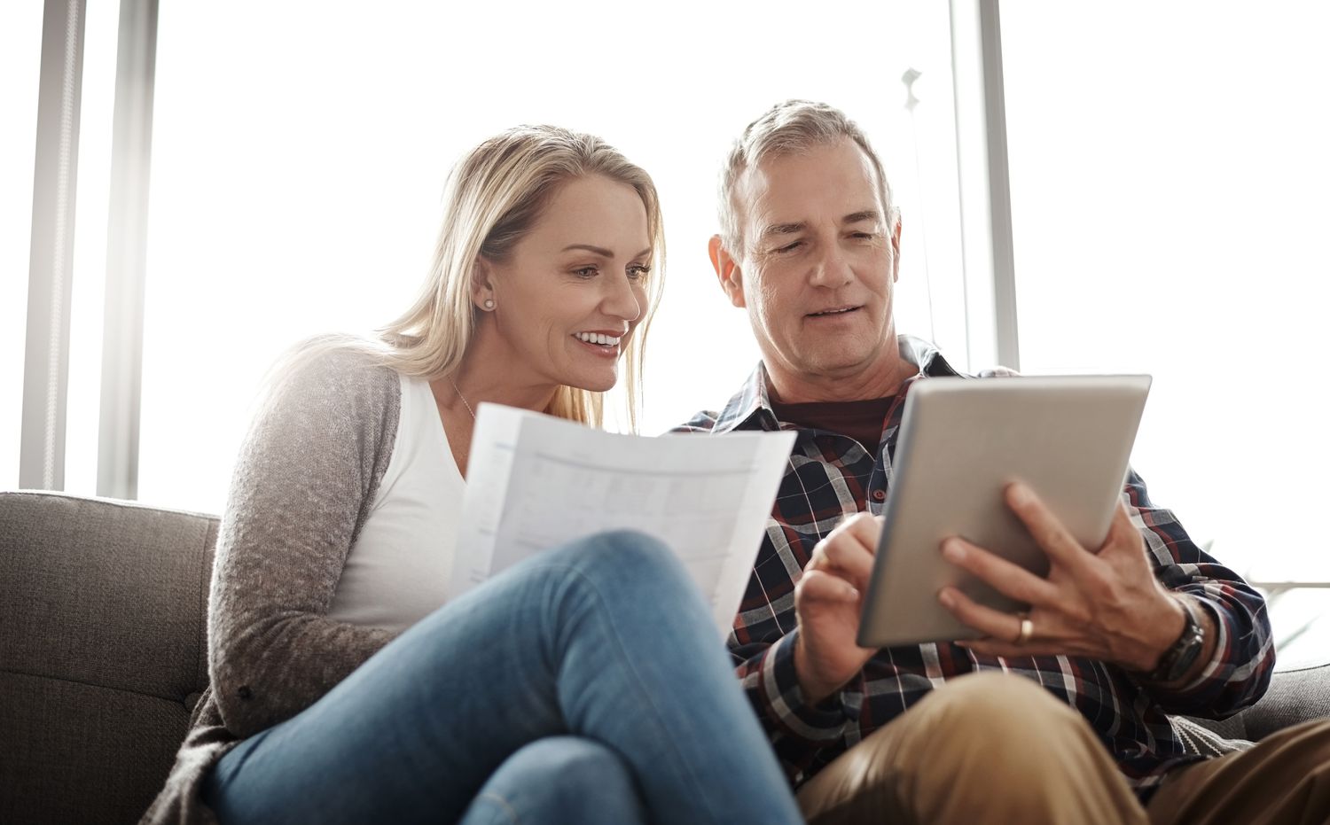 mature couple using tablet to budget