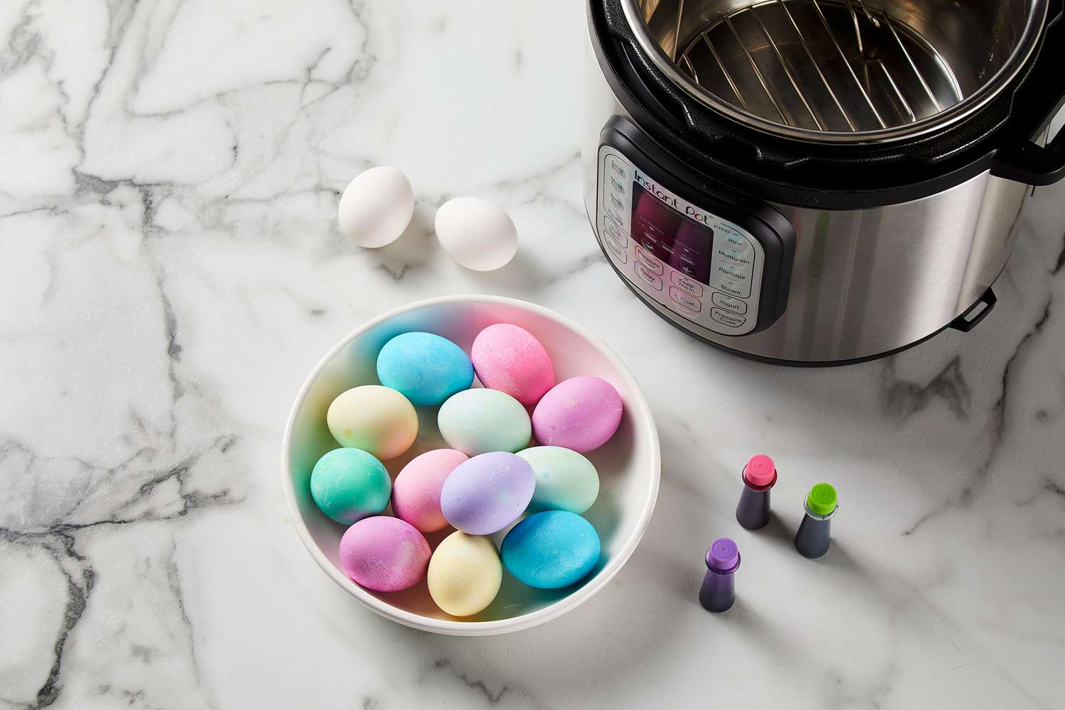 bowl of pastel dyed eggs in bowl next to instant pot and food coloring