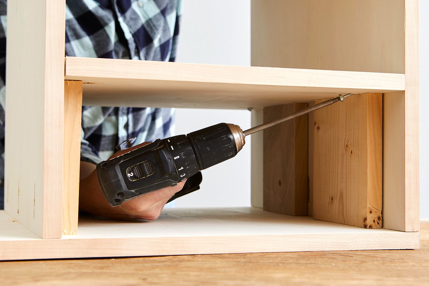screwing shelf in place through pocket holes with support boards