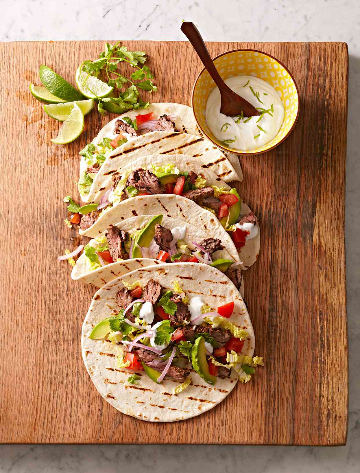 Skirt Steak Tacos with Guacamole and Lime Crema