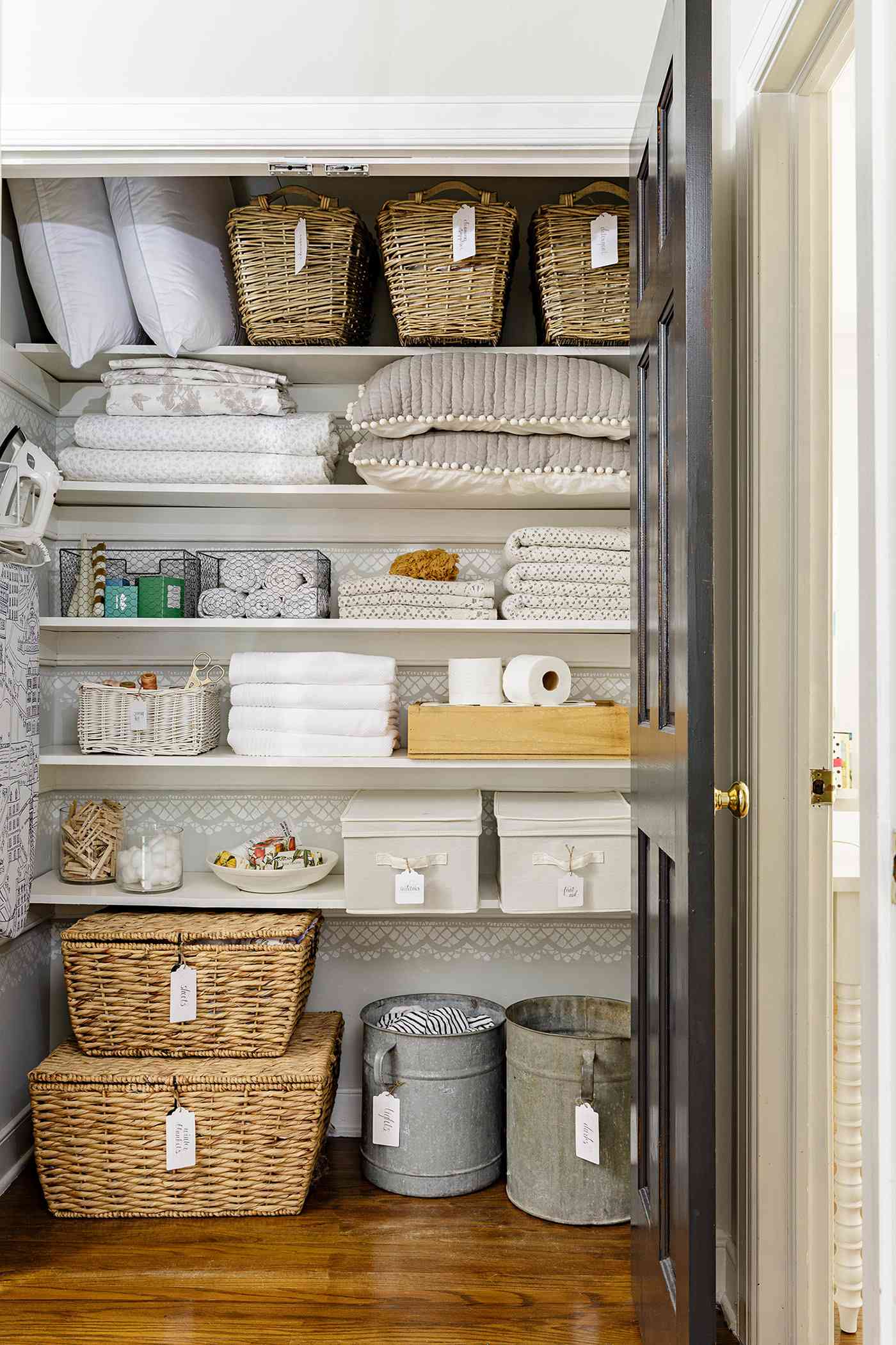linen closet organized with bins and baskets