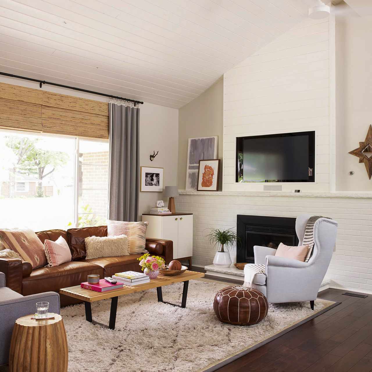 white livingroom with brown couch and grey chairs