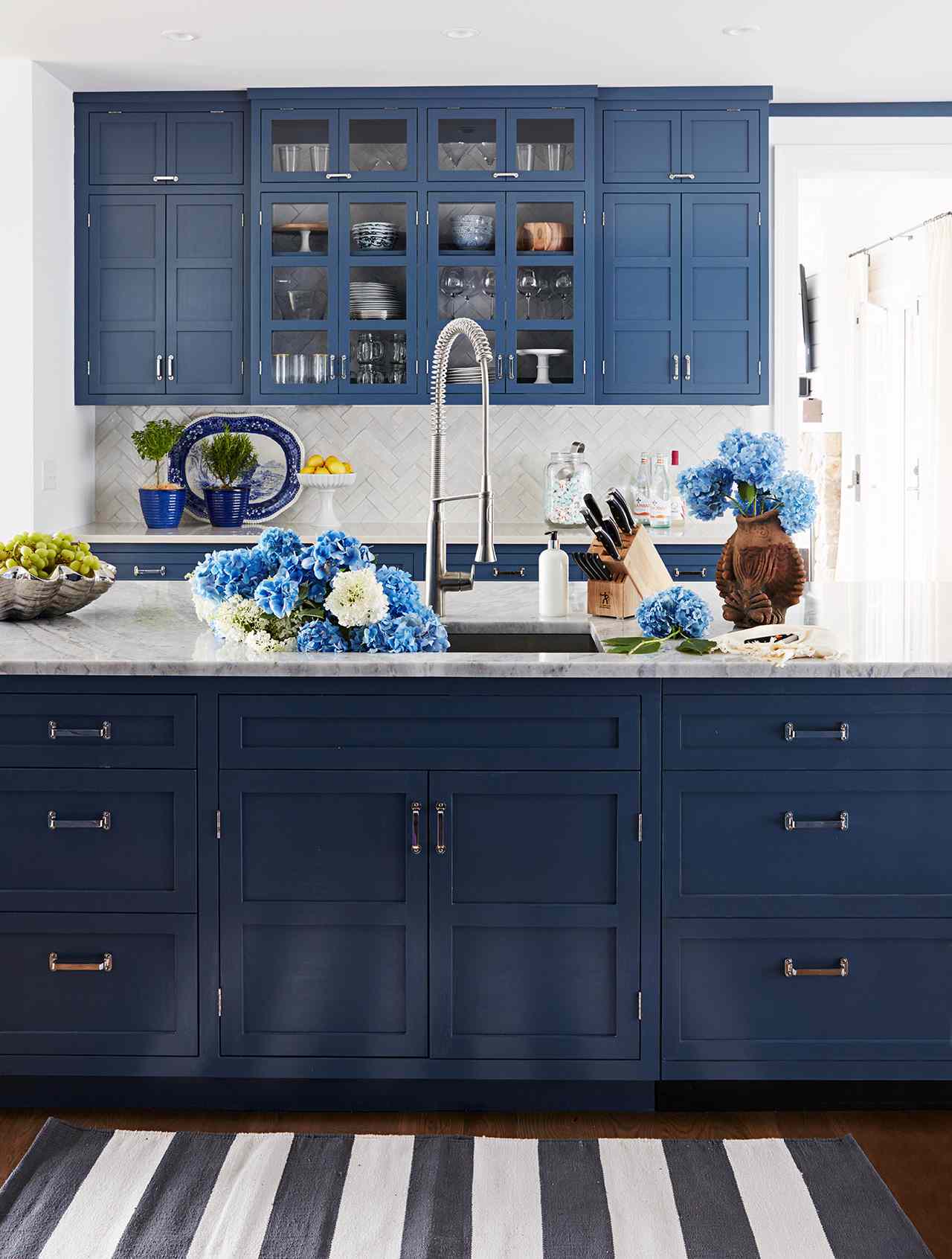 kitchen with dark blue cabinet blue flowers on island