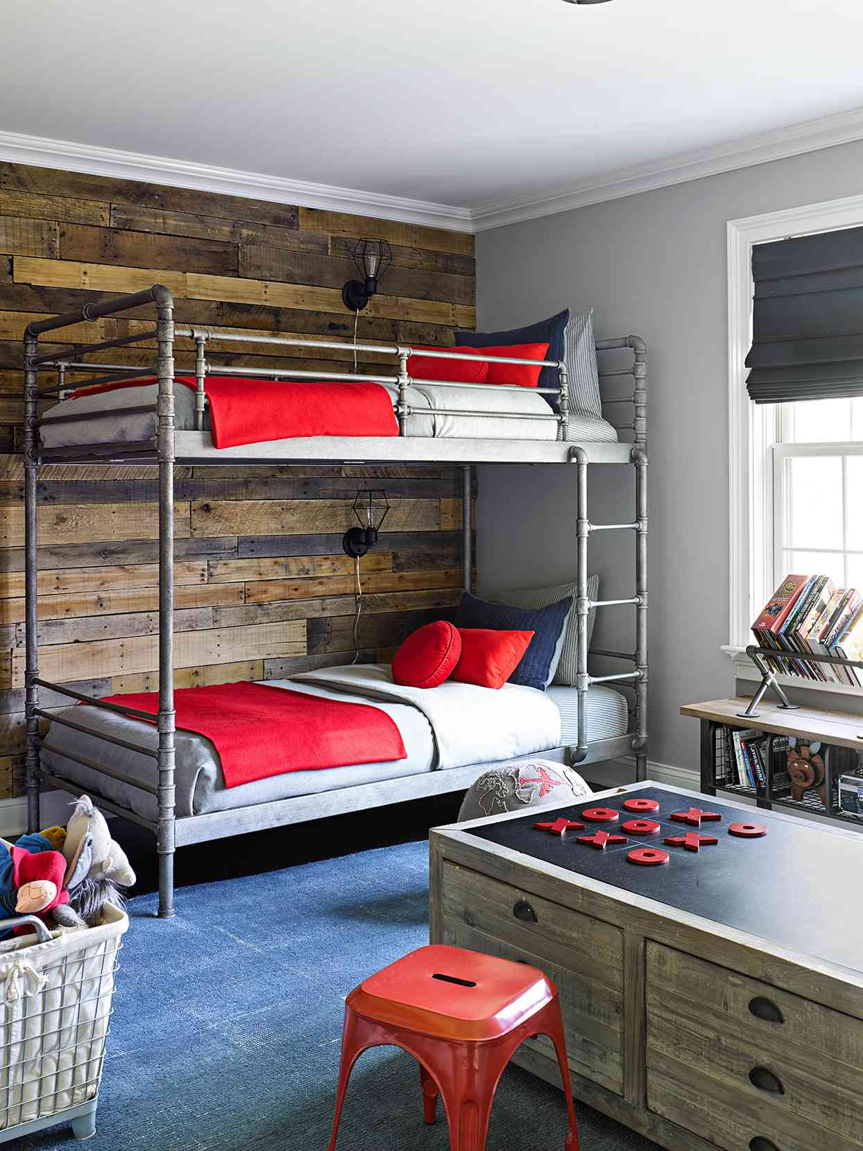 blue bedroom with bunk beds with bright red accents