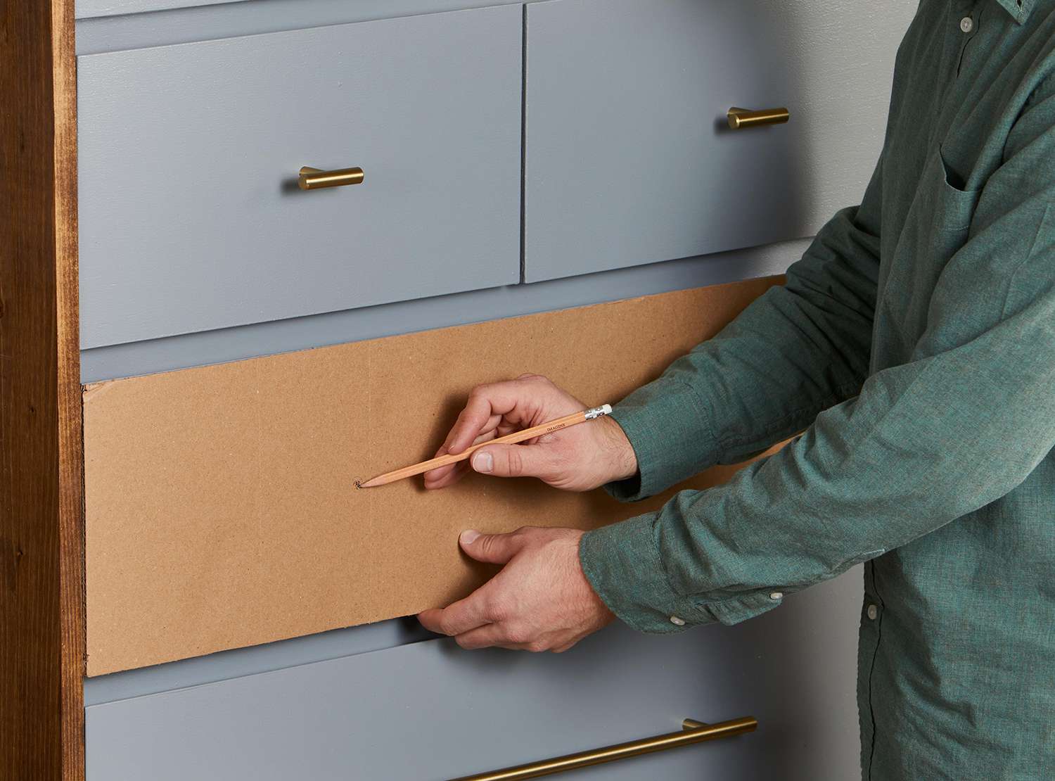 using cardboard and pencil to mark handle position on dresser