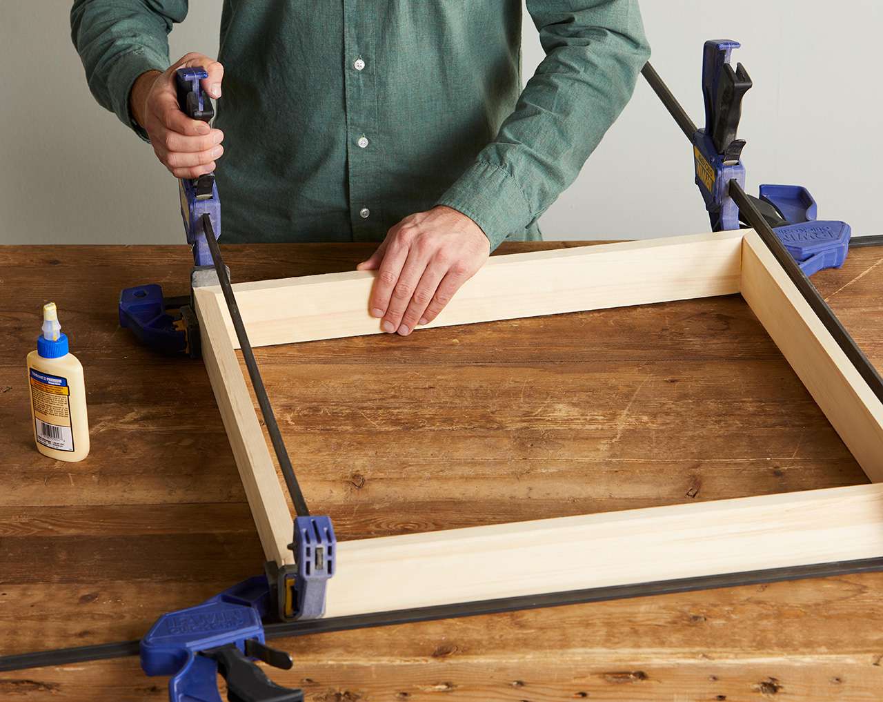 wood glue and clamps holding together canvas frame