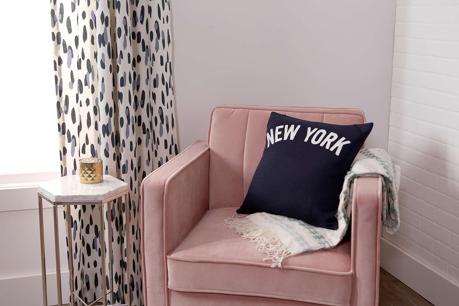 envelope pillow on blush pink chair