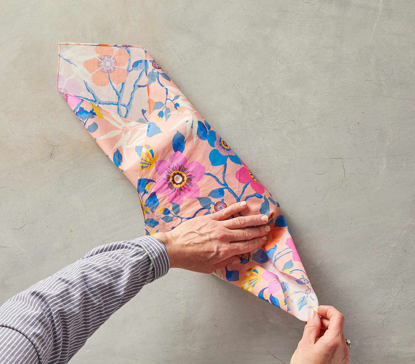 folding point at end of pink flowered fabric