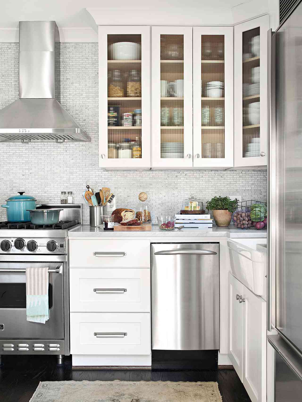 gray and white kitchen with glass cabinet fronts