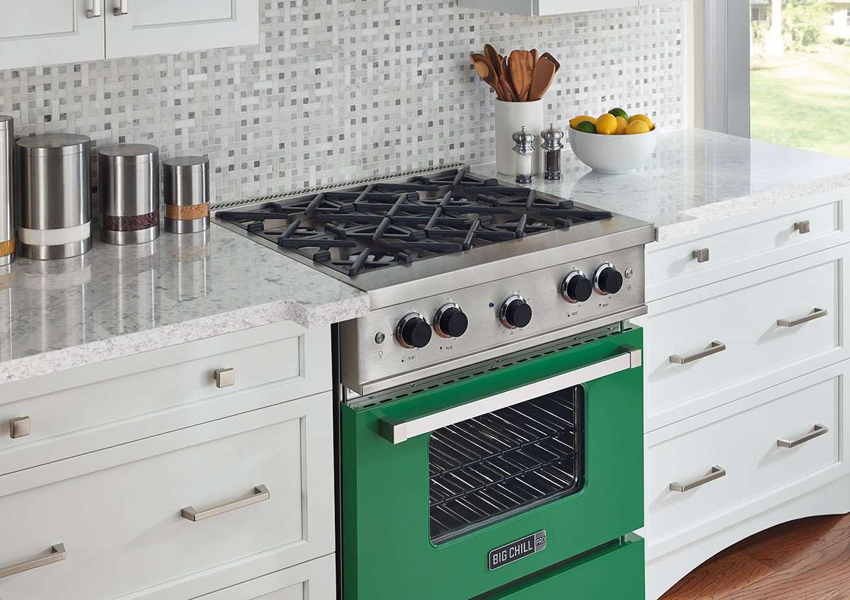 dark green big chill oven in white and gray kitchen
