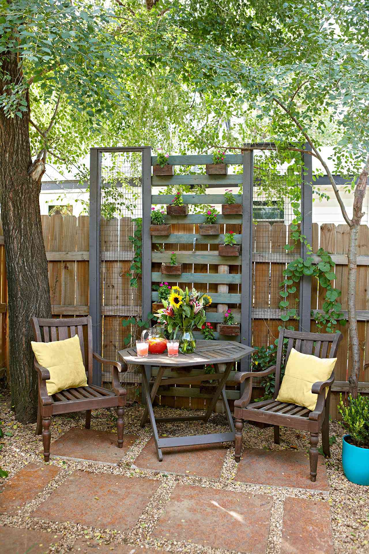 outside wood chair and table with fence planter