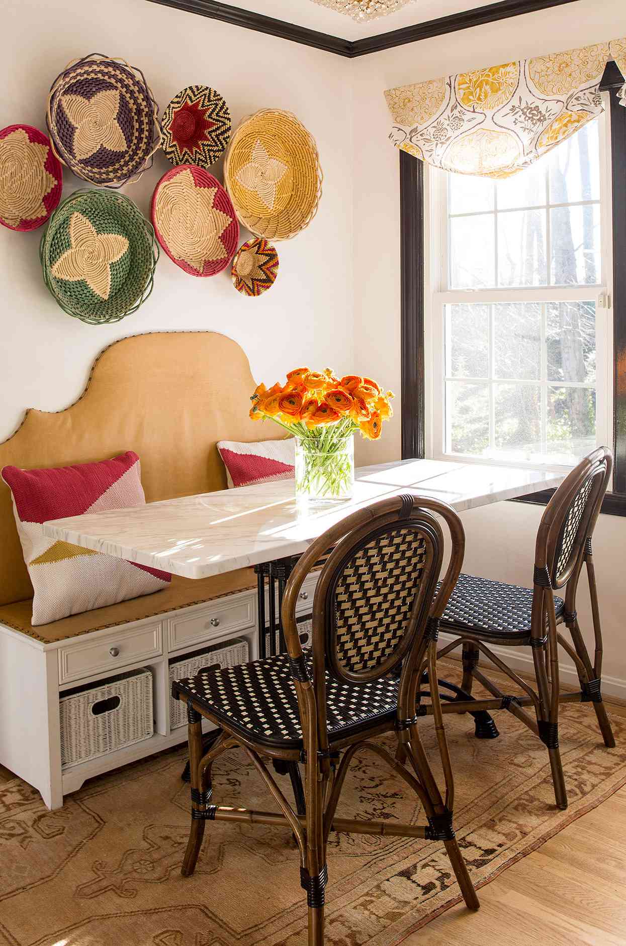 eclectic breakfast banquette with rattan chairs