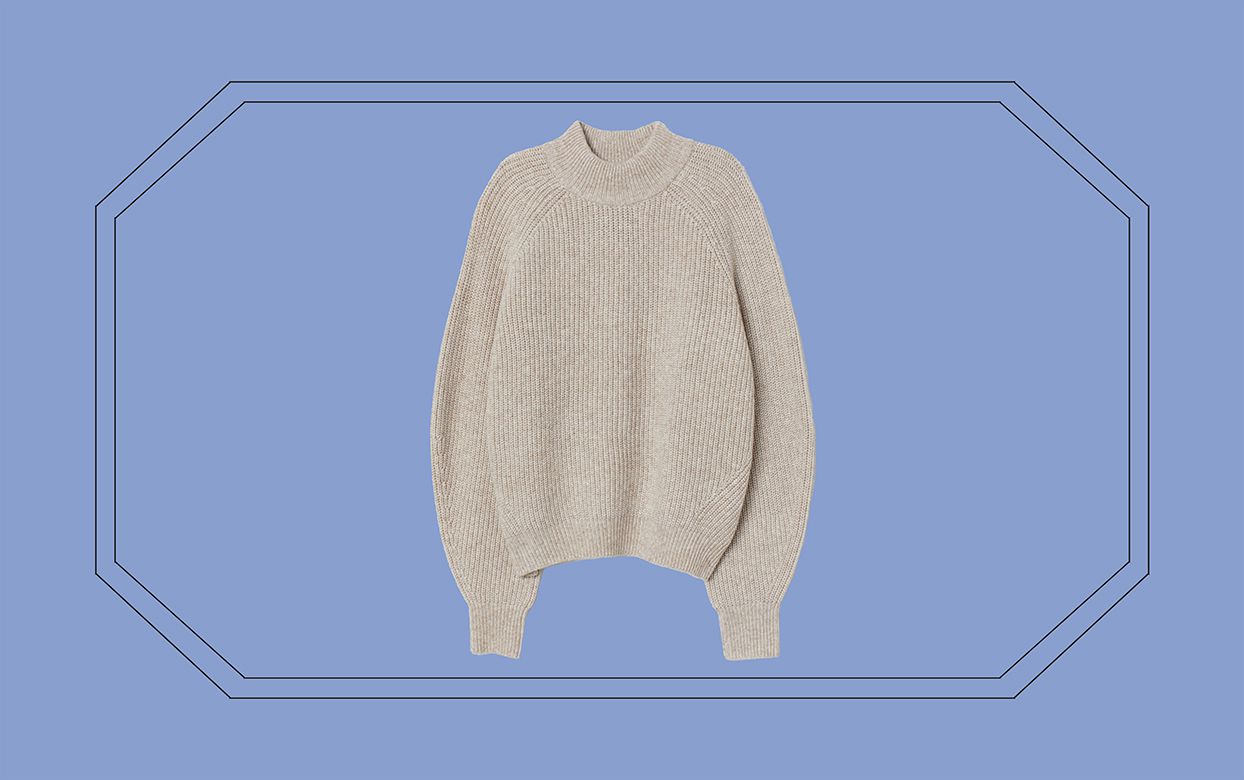 cream colored sweater against blue/purple background