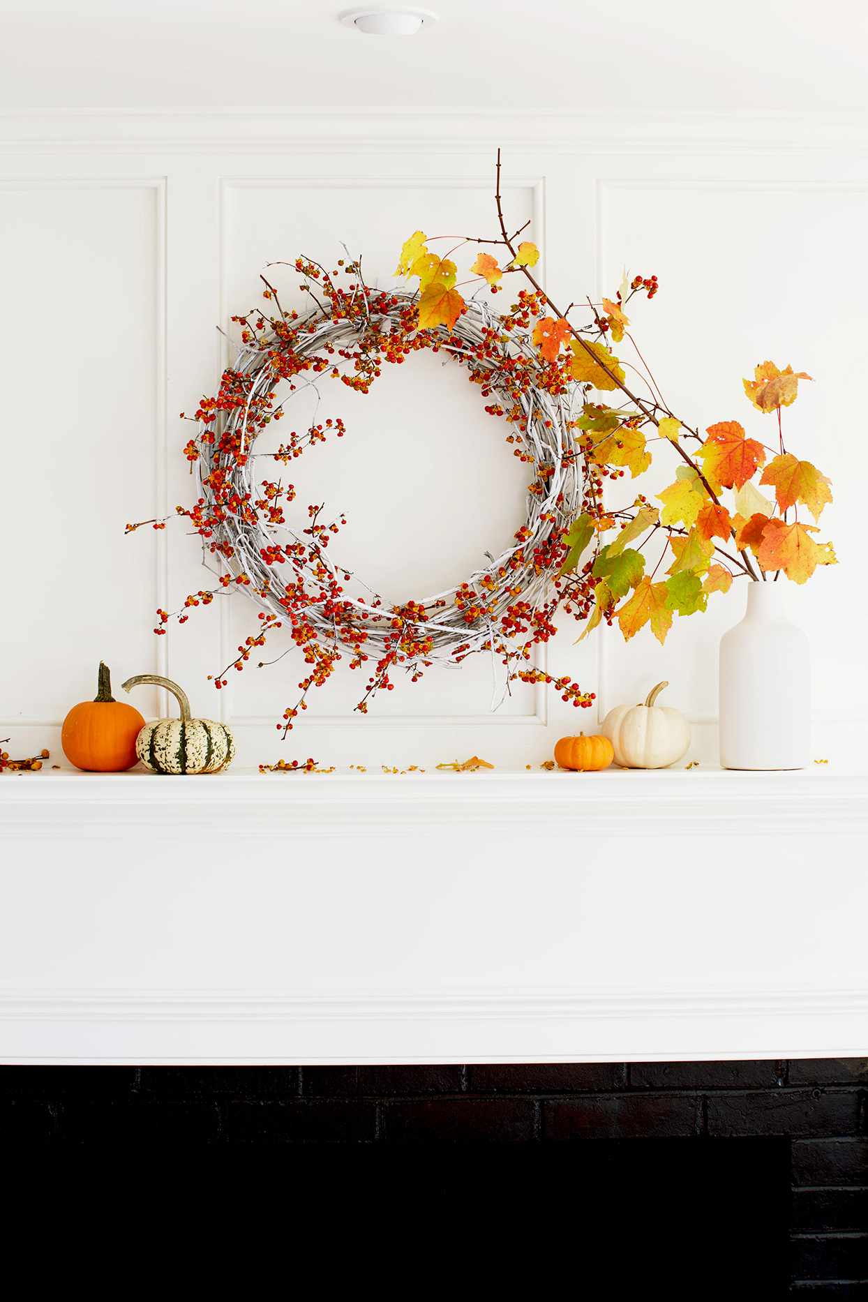 Wreath above fireplace with pumpkins