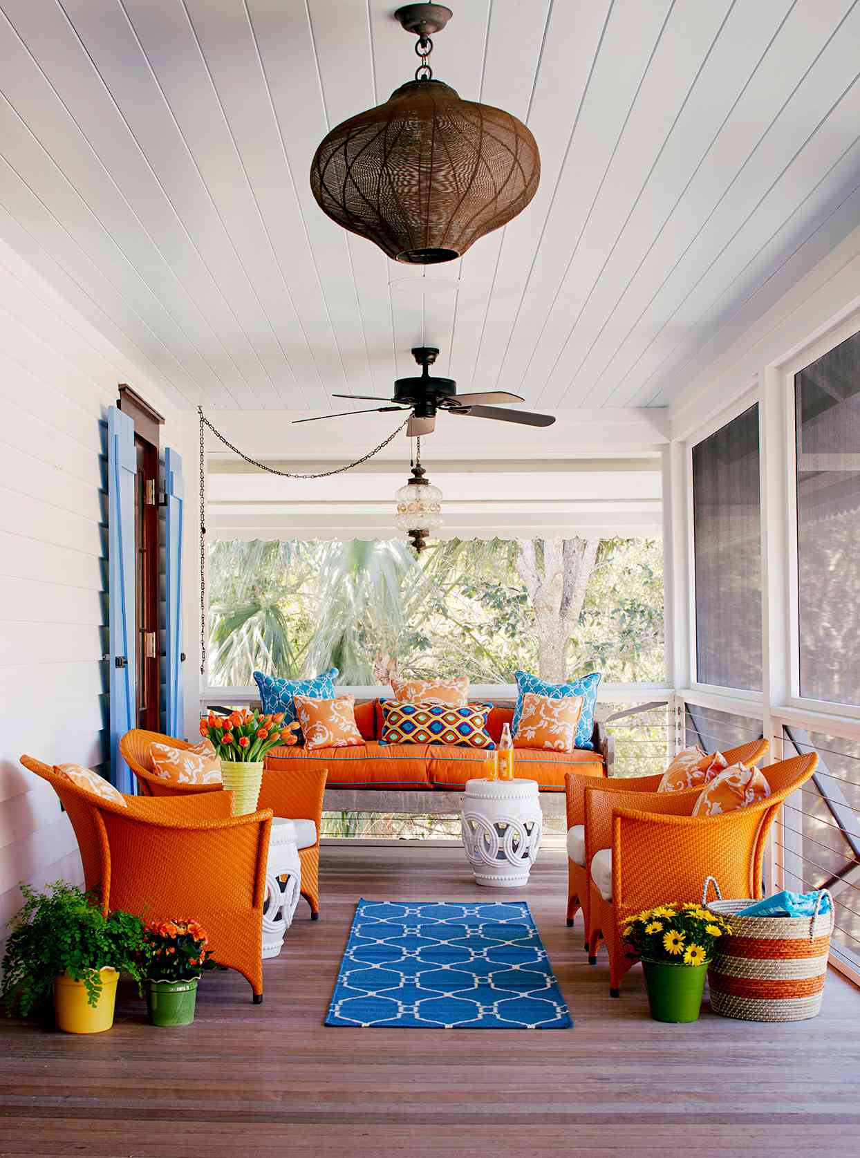 Porch with blue tan theme, chairs, pillows