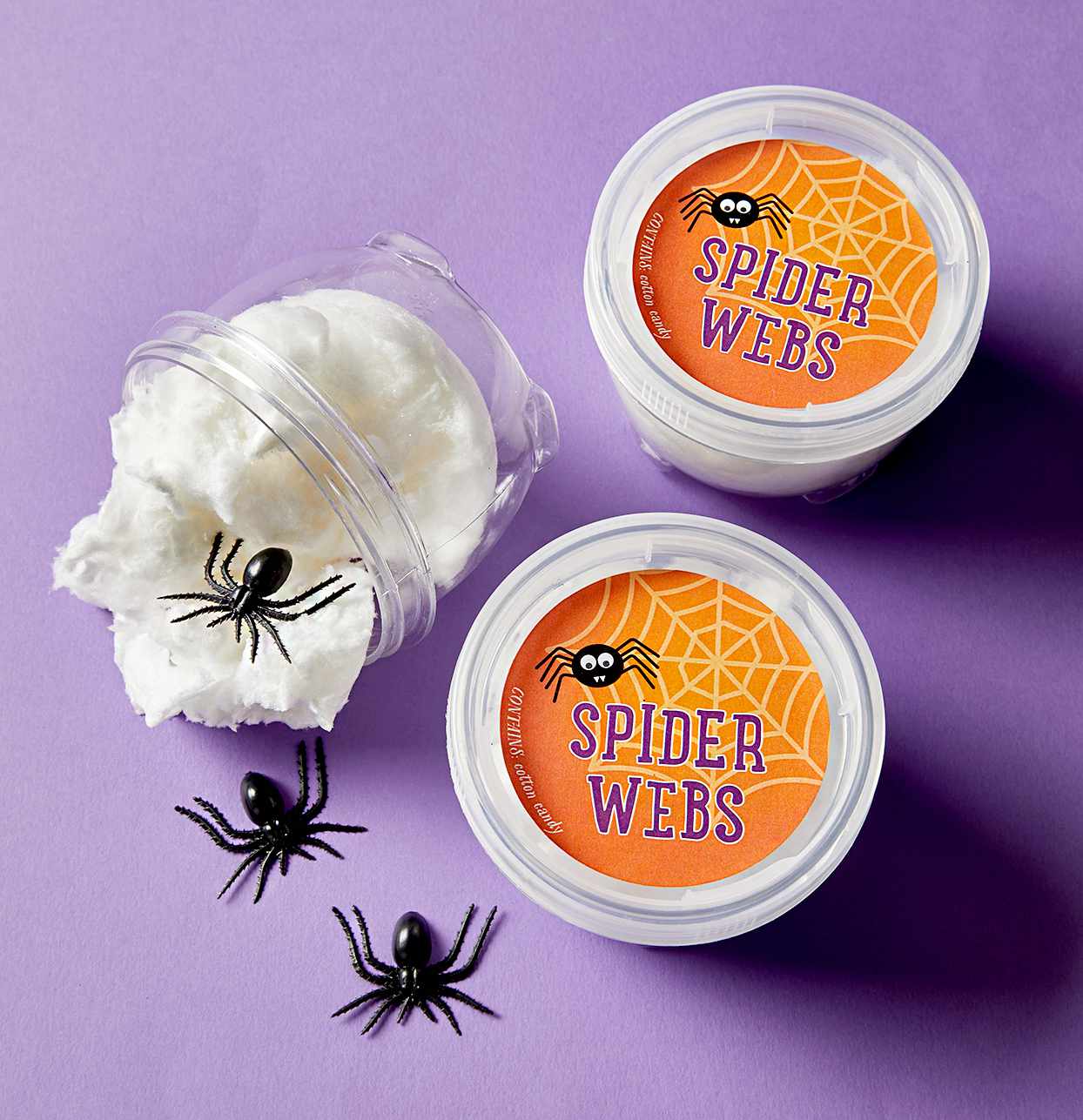 Containers that say "spider webs" with plastic spiders