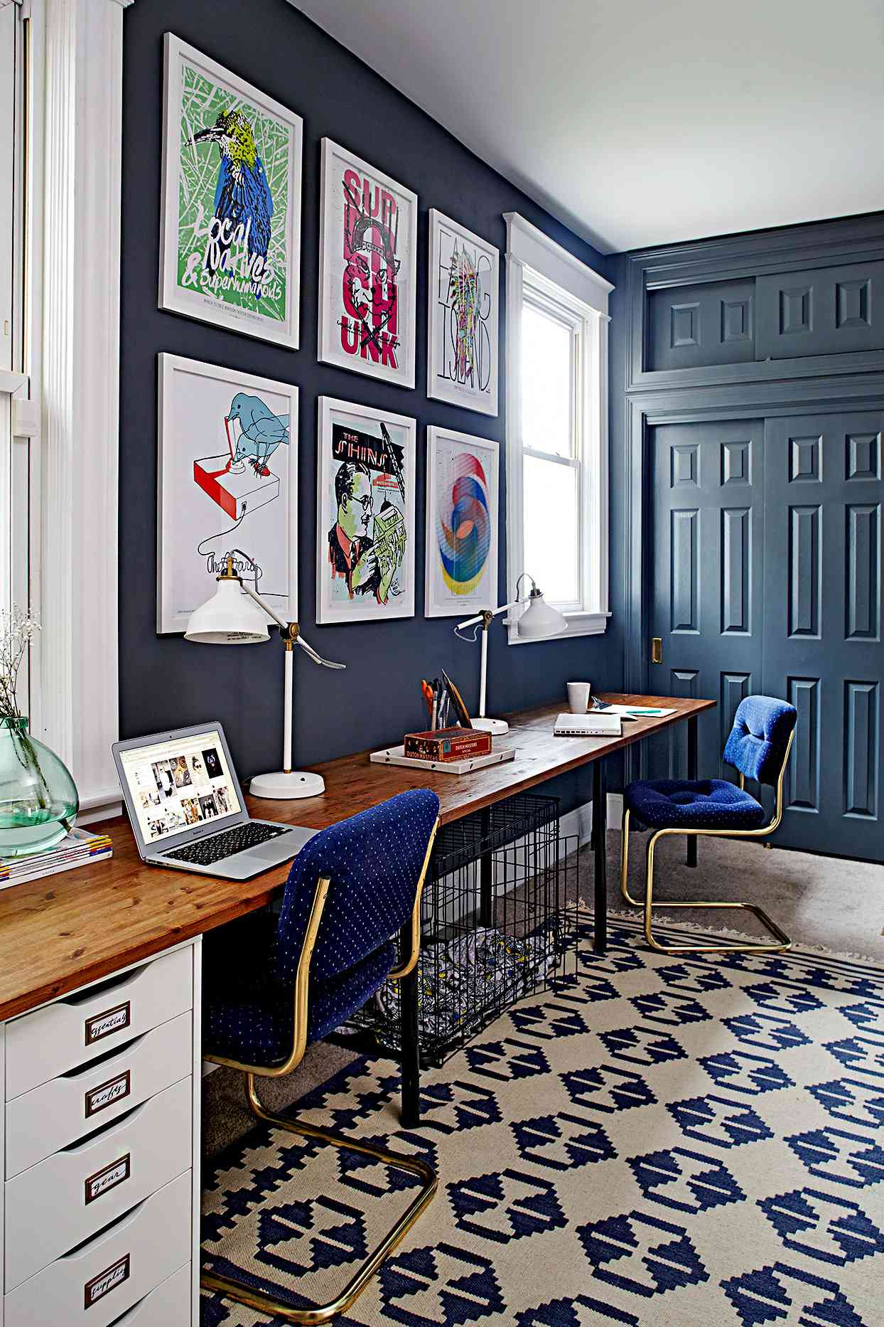 Office area with dark blue walls and large artwork
