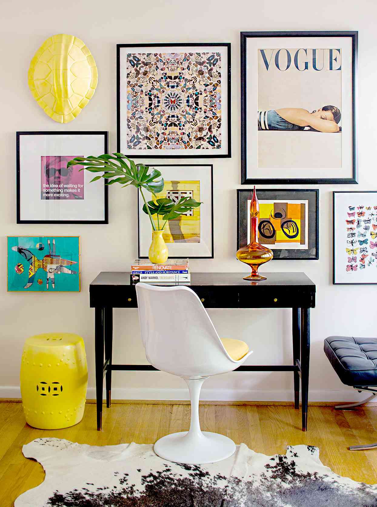Desk with different-sized artwork and posters
