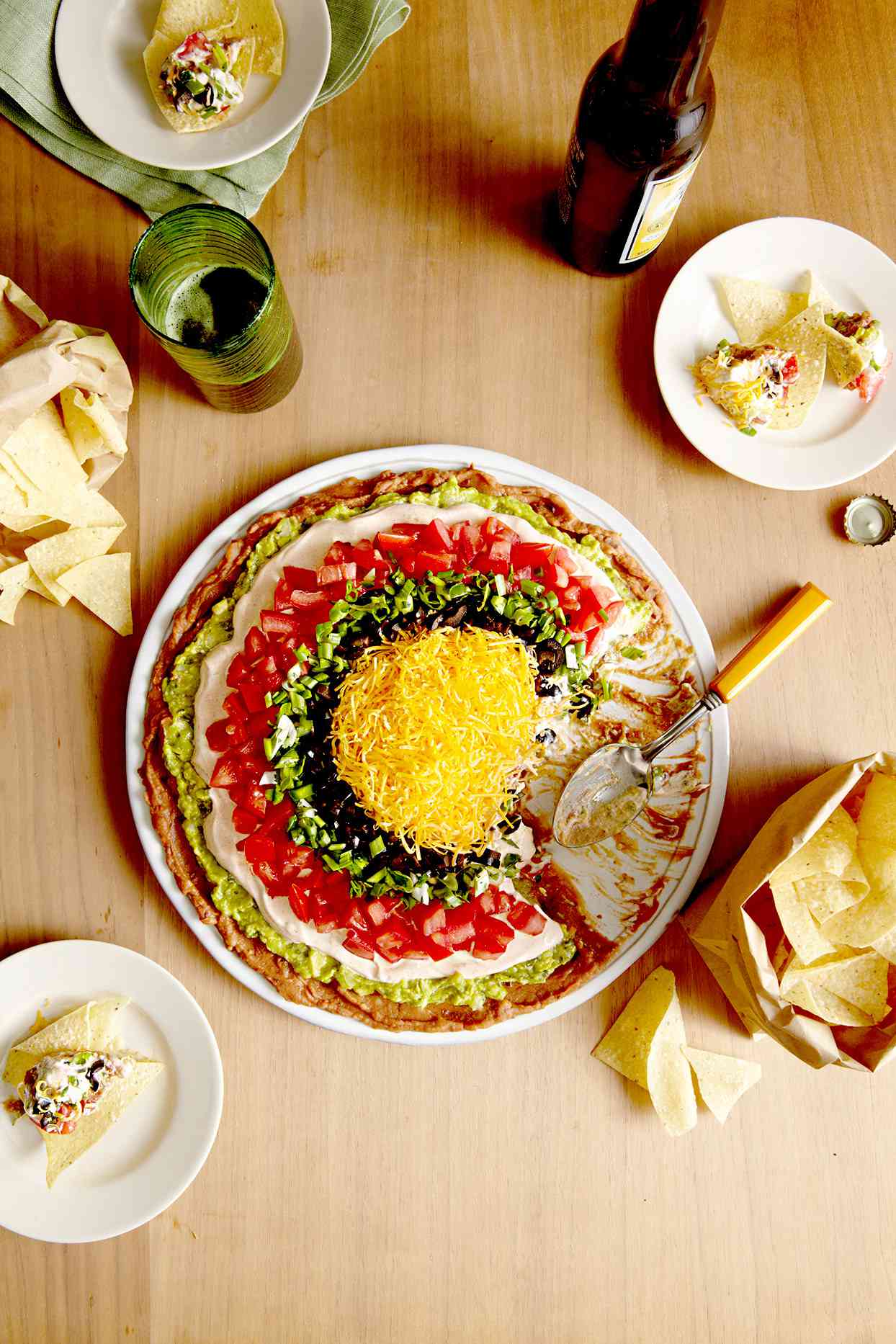 Seven-layer dip on table with chips