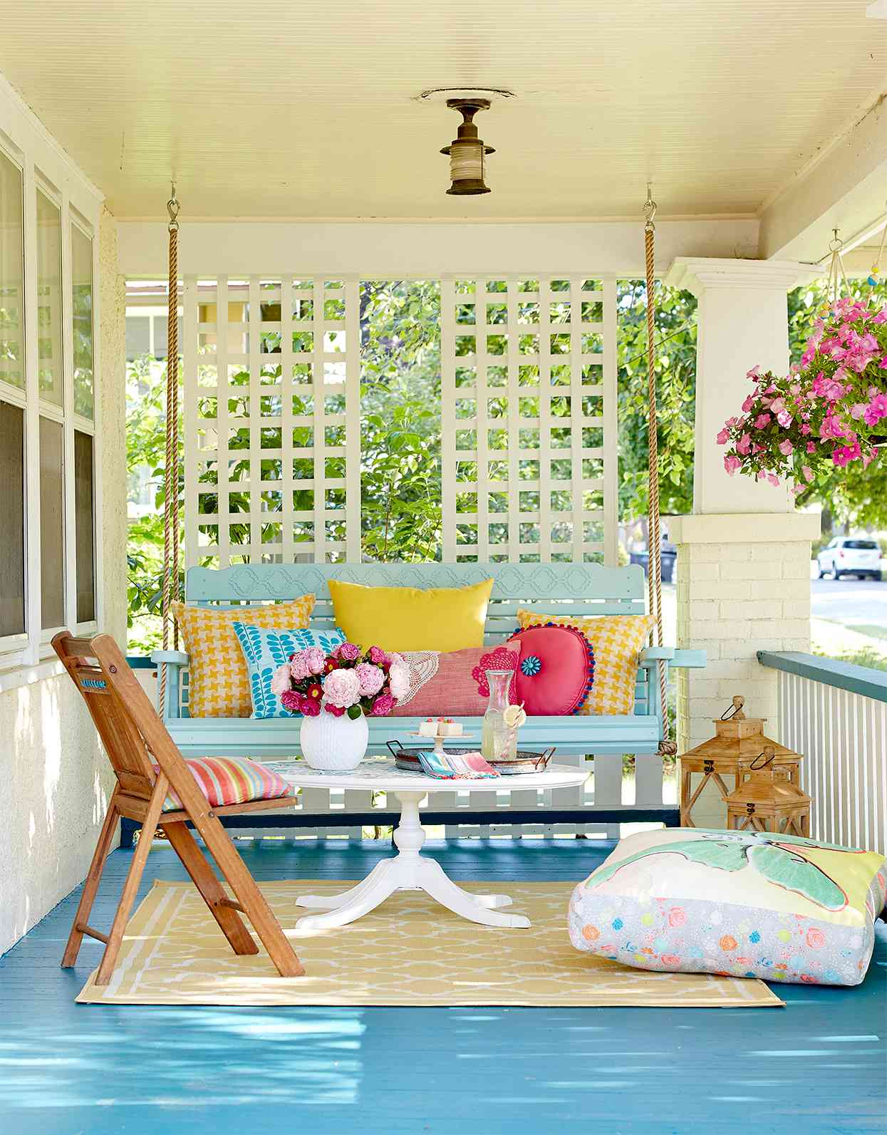 front porch with blue swing and bold painted floor