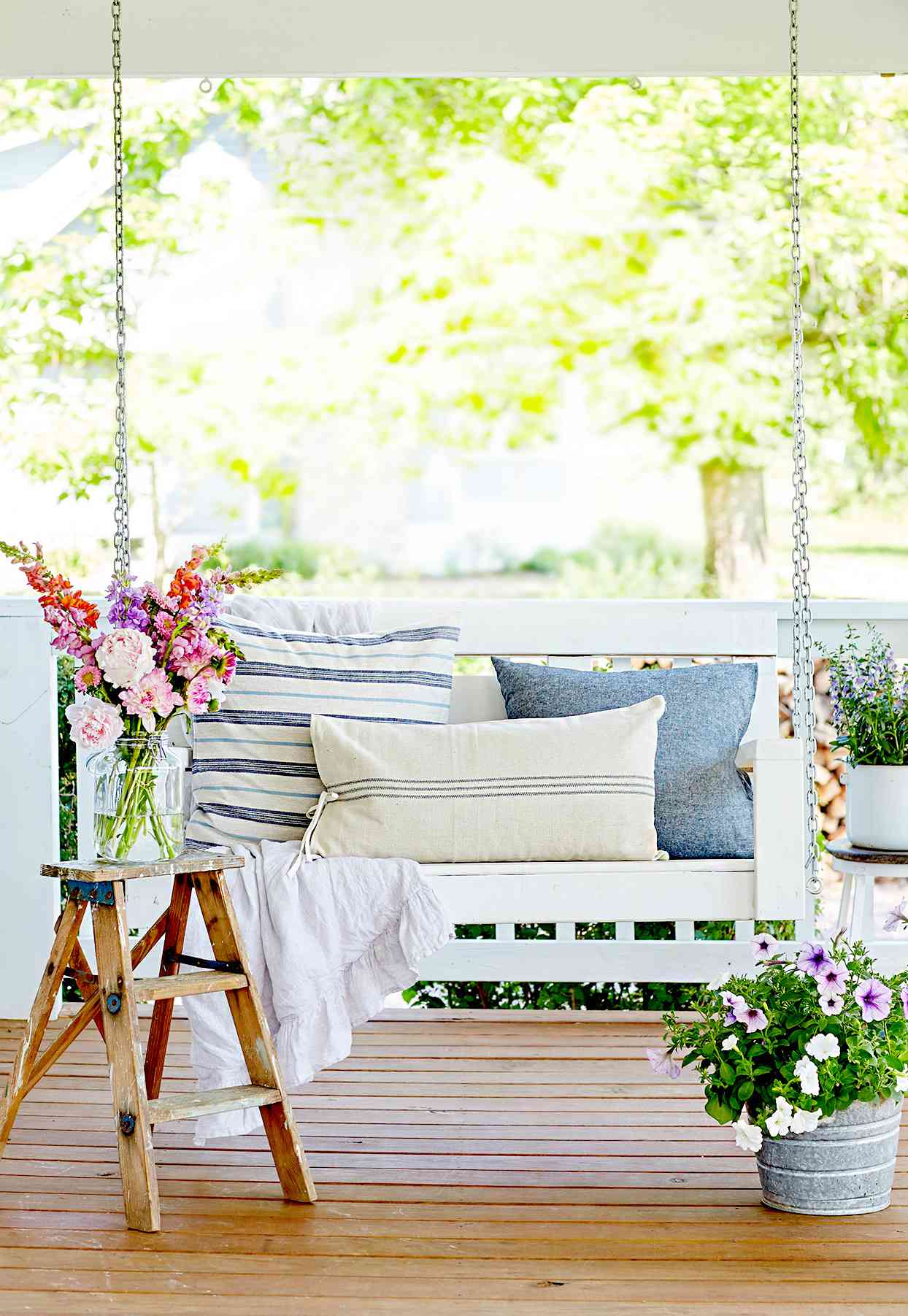 Porch swing with pillows and flowers