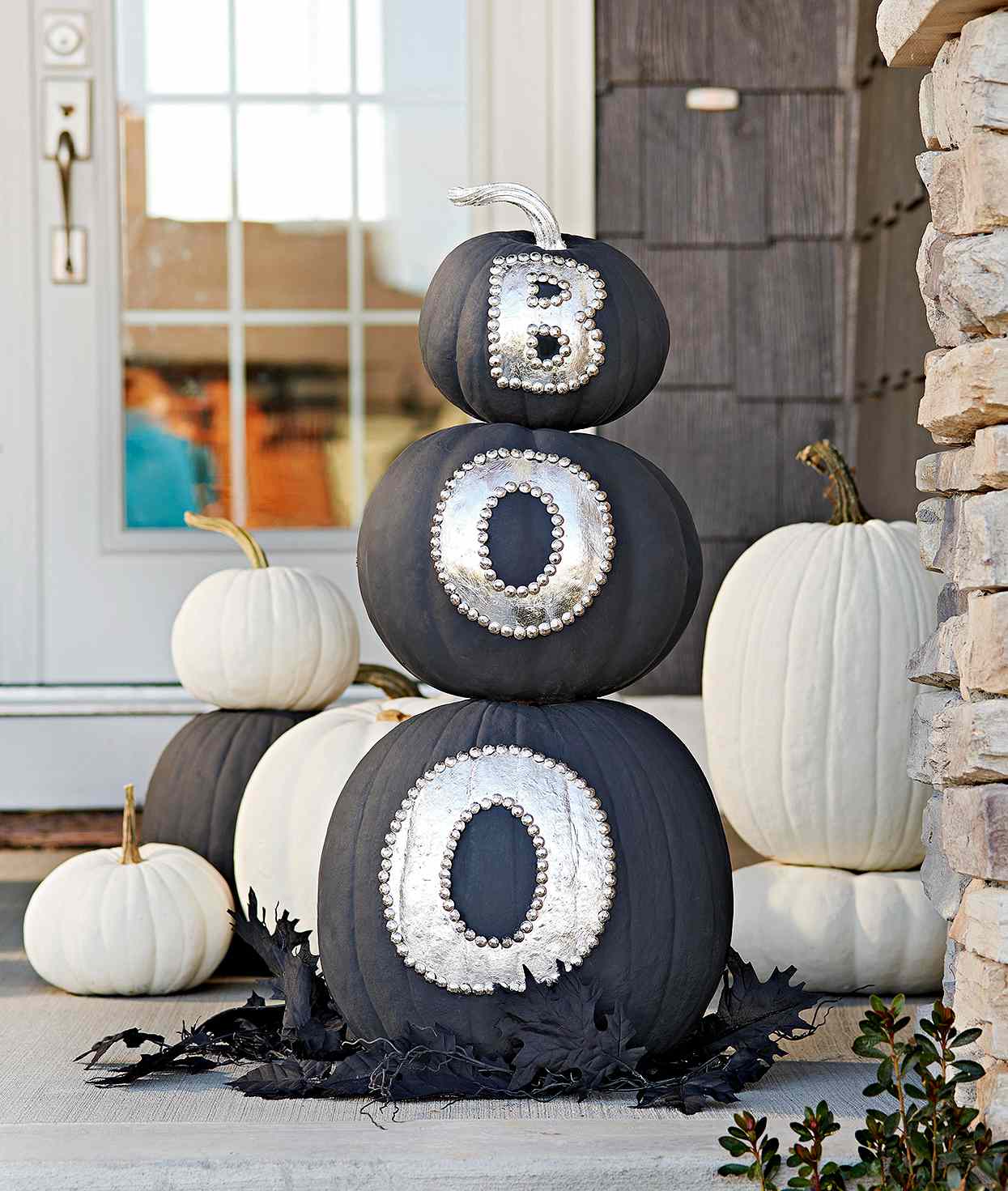 stacked black pumpkins with silver letters