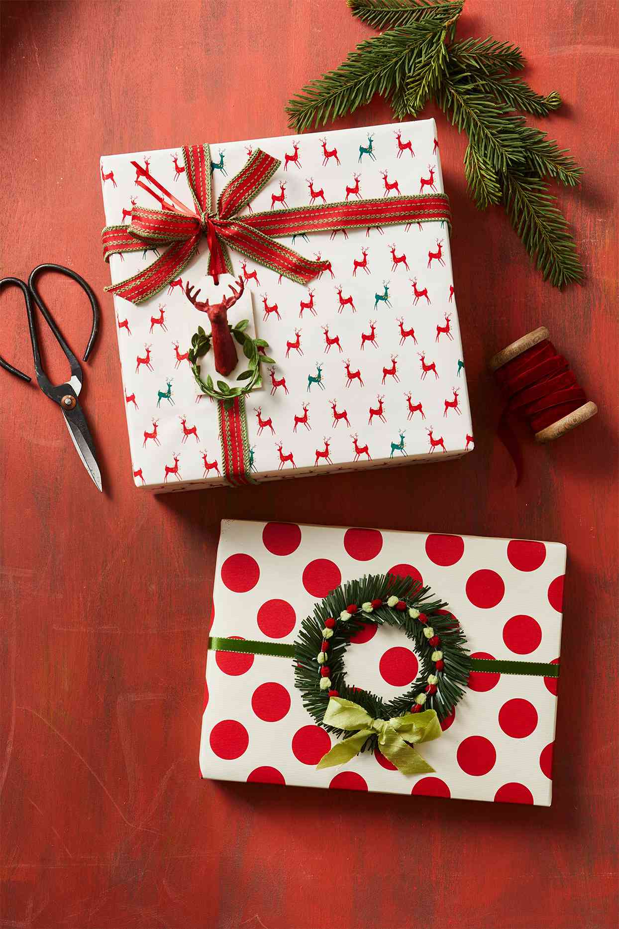 red and white wrapped gifts decorated with wreaths and supplies
